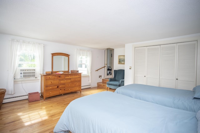 62 Lynde St, Old Saybrook, CT 06475 - bedroom featuring baseboard heating, light wood-style floors, and multiple windows