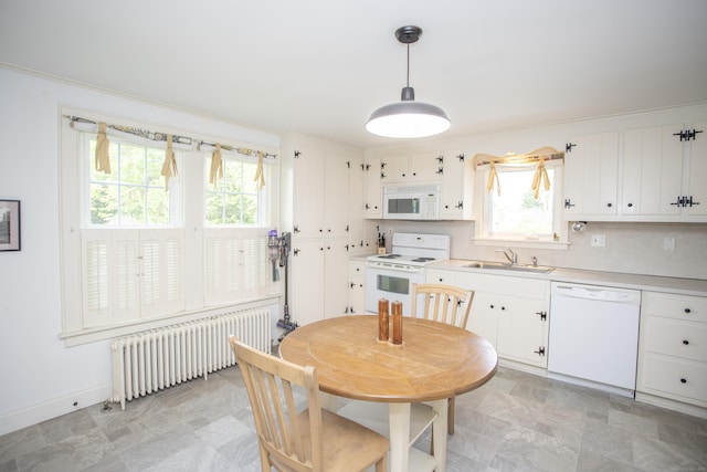 62 Lynde St, Old Saybrook, CT 06475 - kitchen with white appliances, radiator, a sink, and plenty of natural light