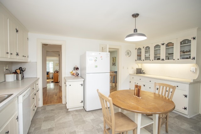 62 Lynde St, Old Saybrook, CT 06475 - kitchen featuring white appliances, white cabinets, light countertops, and glass insert cabinets
