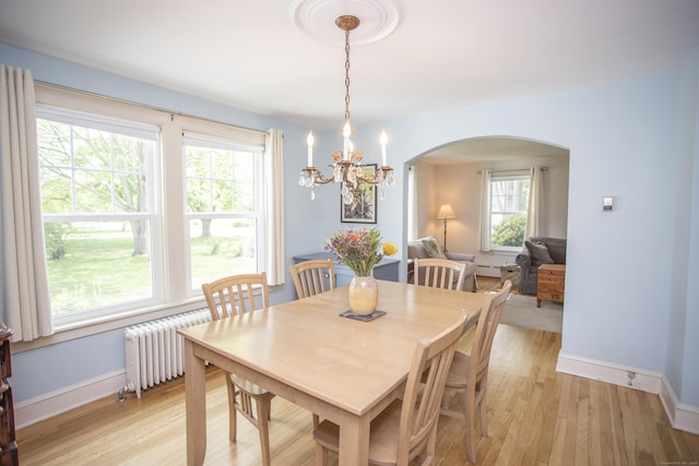 62 Lynde St, Old Saybrook, CT 06475 - dining space with arched walkways, baseboards, light wood finished floors, and healthy amount of natural light