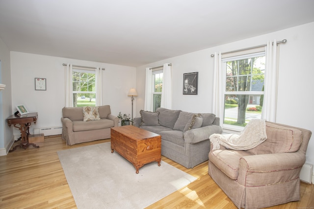 62 Lynde St, Old Saybrook, CT 06475 - living area with a baseboard radiator, plenty of natural light, and light wood-style flooring