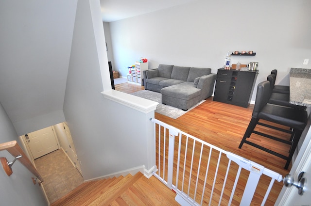 stairs featuring wood finished floors and baseboards