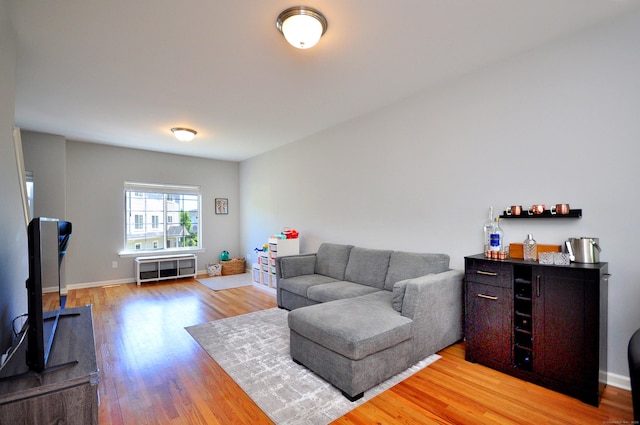 living area featuring light wood-type flooring and baseboards