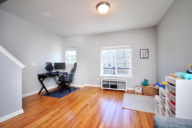 home office featuring wood finished floors, baseboards, and radiator heating unit
