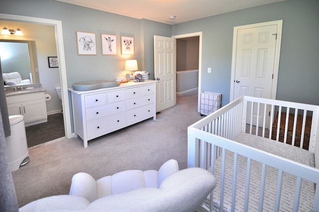 bedroom with light carpet, a nursery area, and baseboards