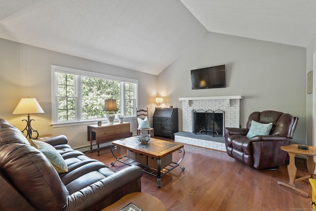 living area featuring baseboard heating, wood finished floors, lofted ceiling, and a brick fireplace