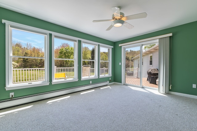 carpeted empty room featuring baseboards, a baseboard radiator, and ceiling fan