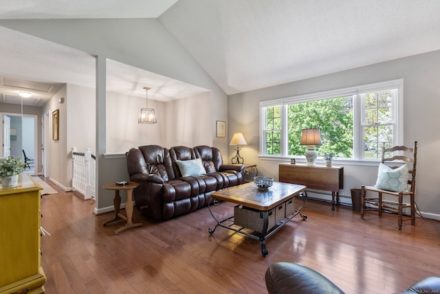 living room with attic access, baseboards, lofted ceiling, and wood-type flooring