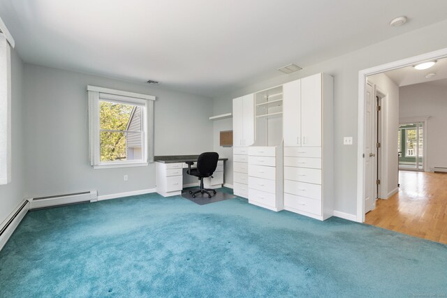unfurnished office featuring carpet, baseboards, and baseboard heating