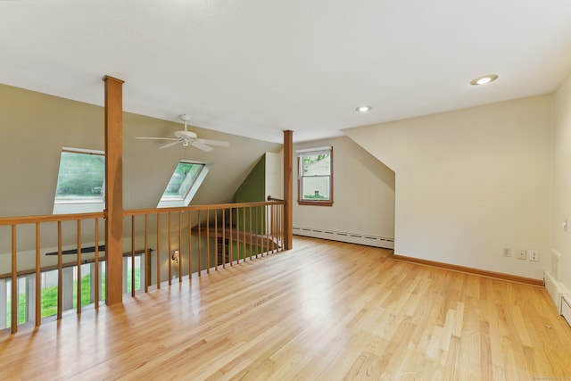 bonus room featuring baseboard heating, a ceiling fan, wood finished floors, baseboards, and recessed lighting