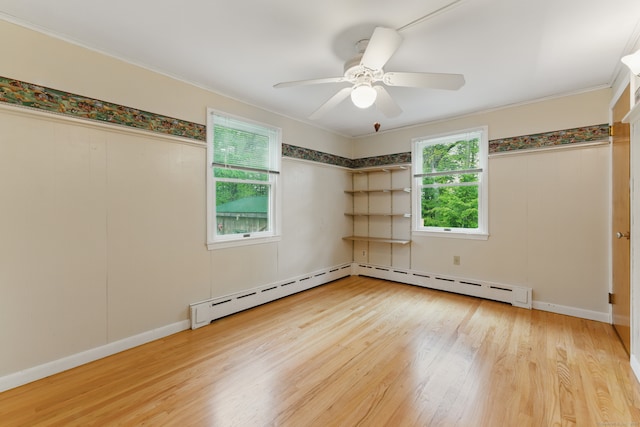 unfurnished room featuring wood finished floors, a ceiling fan, ornamental molding, and a baseboard radiator
