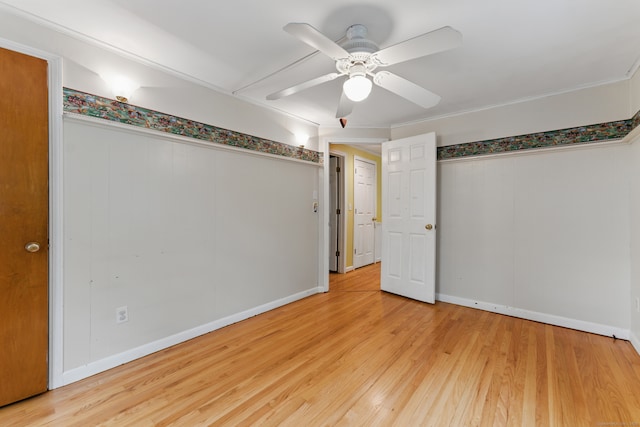 unfurnished bedroom with wood finished floors, ceiling fan, baseboards, and a closet