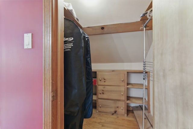 walk in closet with light wood-style floors
