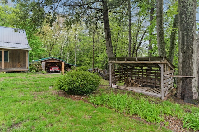 view of green lawn featuring a carport