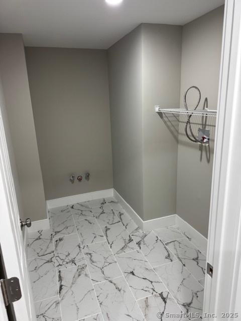 laundry room with baseboards, washer hookup, and marble look tiles