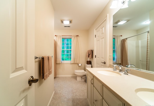 42 N Woods Rd, Hamden, CT 06518 - full bathroom with baseboards, tile patterned floors, toilet, double vanity, and a shower with shower curtain