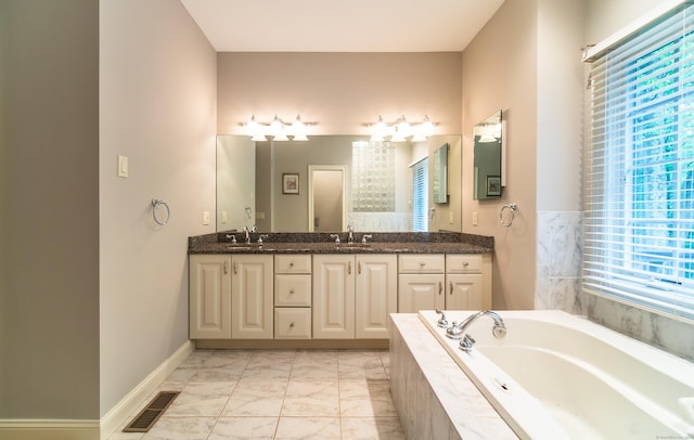 42 N Woods Rd, Hamden, CT 06518 - bathroom featuring healthy amount of natural light, marble finish floors, a garden tub, and double vanity