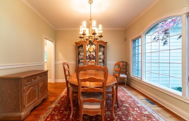 42 N Woods Rd, Hamden, CT 06518 - dining space featuring a chandelier, wood finished floors, ornamental molding, and baseboards