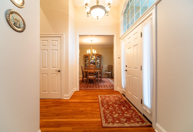 42 N Woods Rd, Hamden, CT 06518 - entrance foyer with a chandelier, wood finished floors, a high ceiling, crown molding, and baseboards