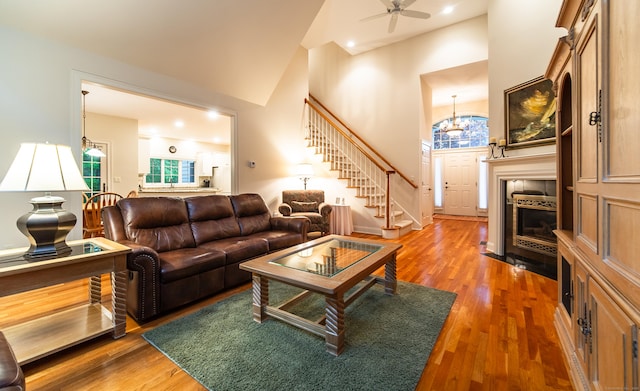 42 N Woods Rd, Hamden, CT 06518 - living area featuring stairs, healthy amount of natural light, wood finished floors, a towering ceiling, and ceiling fan