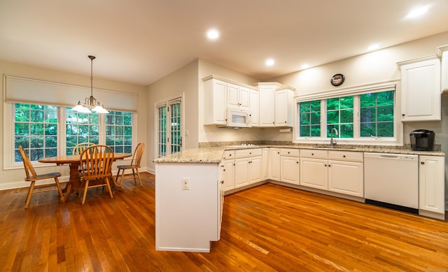 42 N Woods Rd, Hamden, CT 06518 - kitchen with white appliances, a sink, dark wood finished floors, a peninsula, and white cabinets