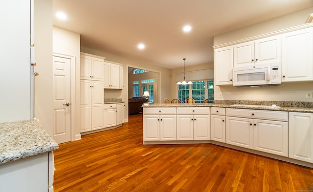 42 N Woods Rd, Hamden, CT 06518 - kitchen featuring white appliances, a peninsula, wood finished floors, white cabinetry, and recessed lighting