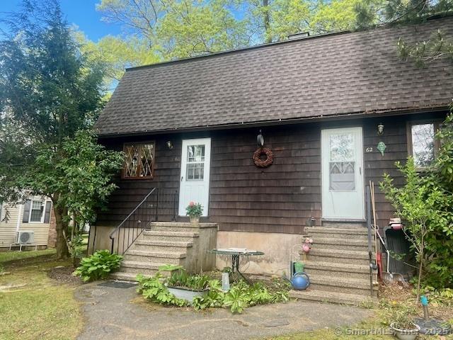 view of front of property featuring entry steps and a shingled roof