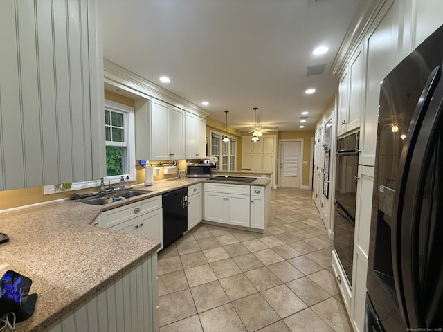 kitchen with ceiling fan, a sink, white cabinetry, a peninsula, and black appliances