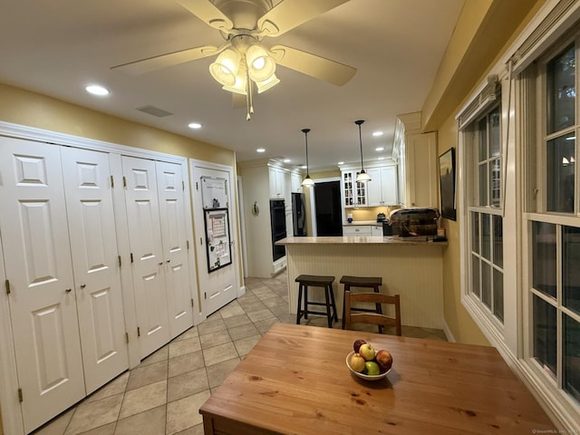 dining area with light tile patterned floors, visible vents, a ceiling fan, and recessed lighting