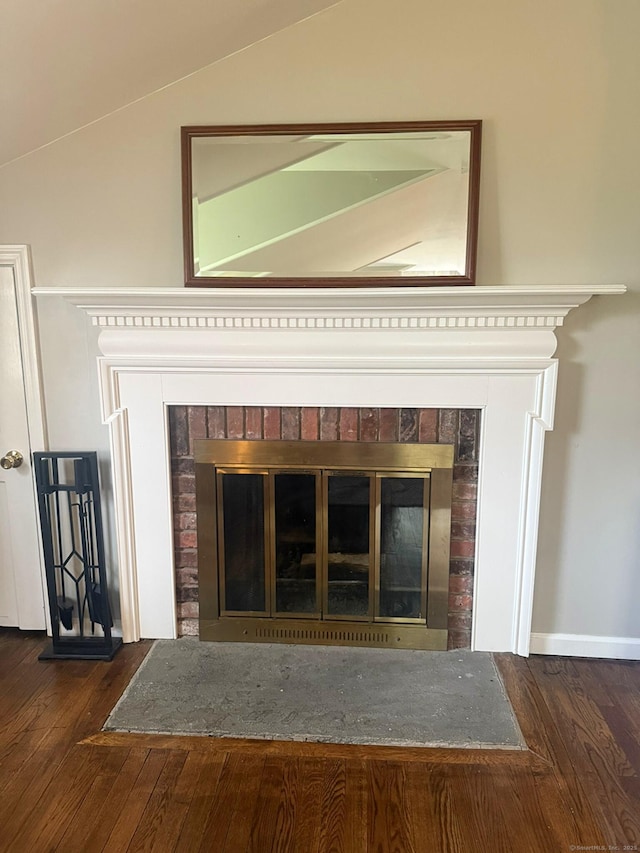 room details with wood finished floors and a brick fireplace