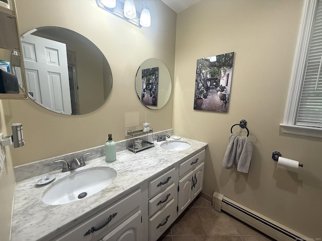 full bathroom featuring a sink, a baseboard radiator, double vanity, and tile patterned floors