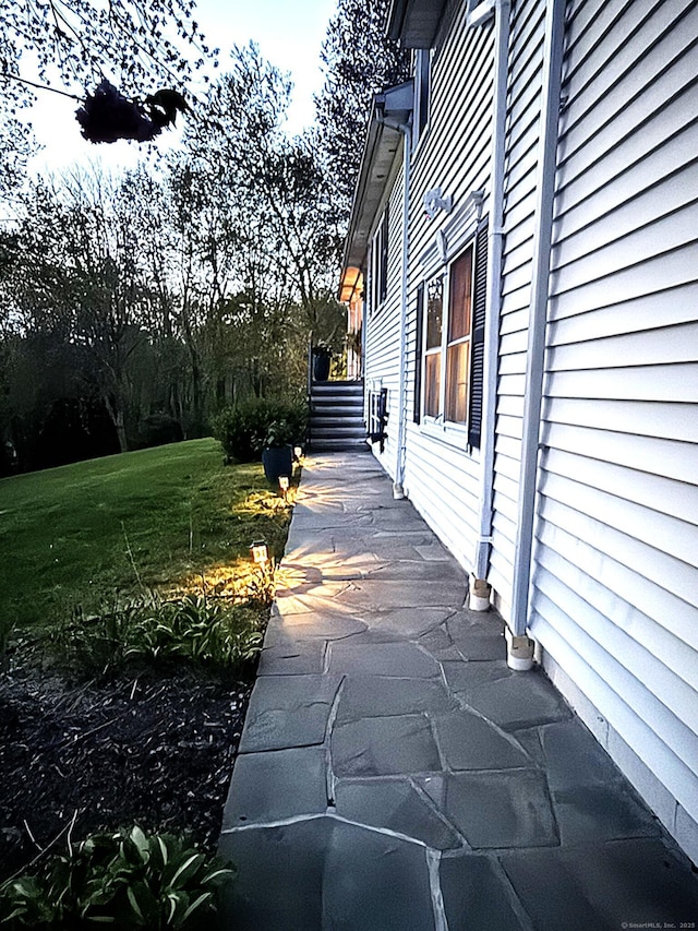 view of property exterior with a yard