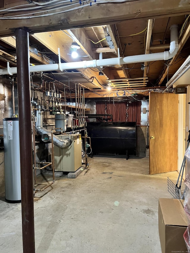 unfinished below grade area with a heating unit, heating fuel, and gas water heater
