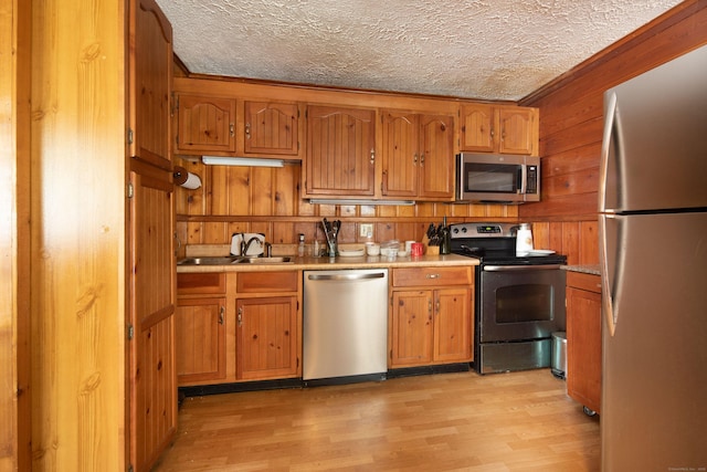 174 Bunker Hill Rd, Cornwall, CT 06796 - kitchen with appliances with stainless steel finishes, light wood-style flooring, light countertops, brown cabinets, and a textured ceiling