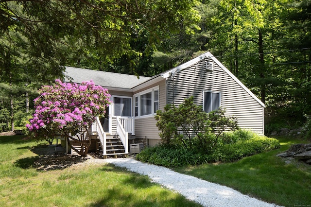 174 Bunker Hill Rd, Cornwall, CT 06796 - ranch-style home featuring a front yard, roof with shingles, and a sunroom
