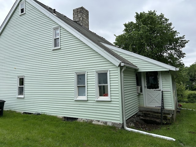 80 Colony St, Ansonia, CT 06401 - view of property exterior featuring a chimney, a yard, and entry steps