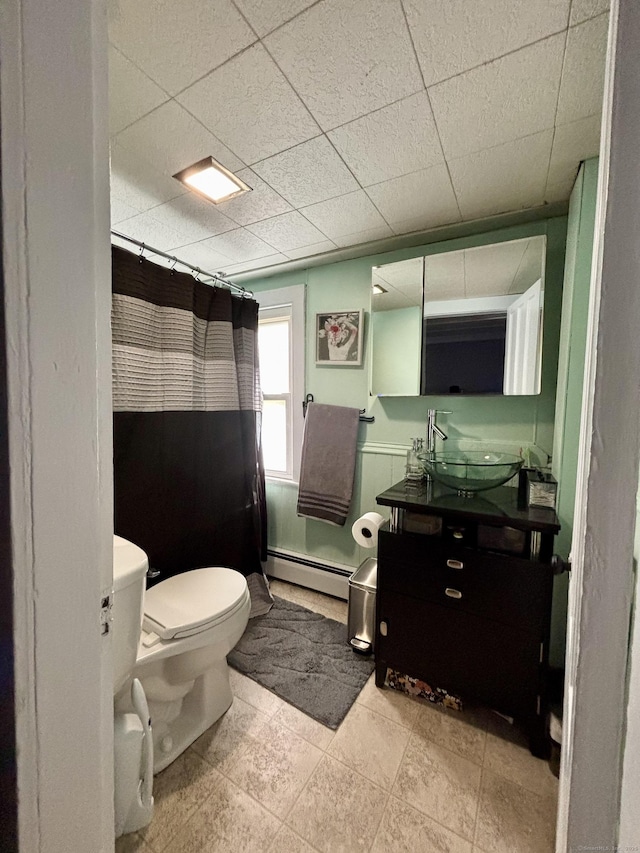80 Colony St, Ansonia, CT 06401 - bathroom with a baseboard heating unit, vanity, toilet, a shower with shower curtain, and a paneled ceiling