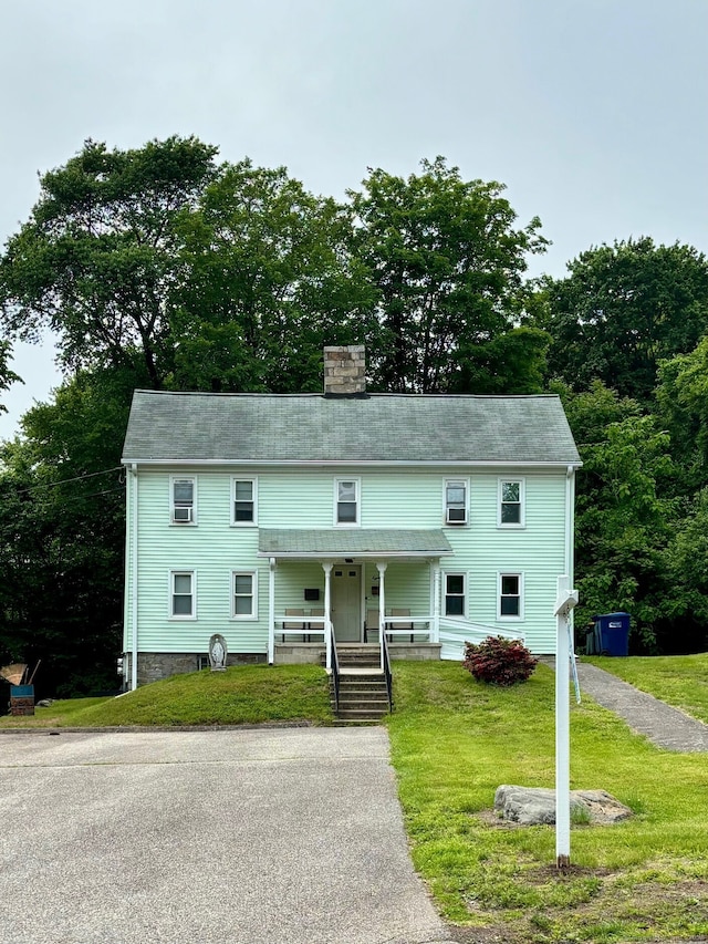80 Colony St, Ansonia, CT 06401 - view of front of home featuring a chimney, a porch, and a front yard