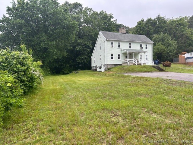 80 Colony St, Ansonia, CT 06401 - view of front of house with a chimney and a front yard