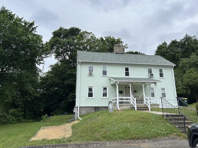 80 Colony St, Ansonia, CT 06401 - view of front of house with a chimney, covered porch, and a front lawn