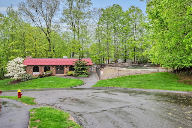 40 Woodsedge Dr Apt 2C, Newington, CT 06111 - view of front of house with brick siding, a chimney, and asphalt driveway