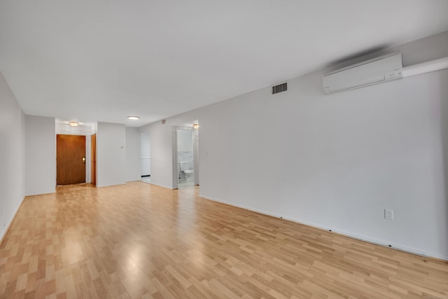 40 Woodsedge Dr Apt 2C, Newington, CT 06111 - unfurnished room with a wall unit AC, light wood-style flooring, and baseboards