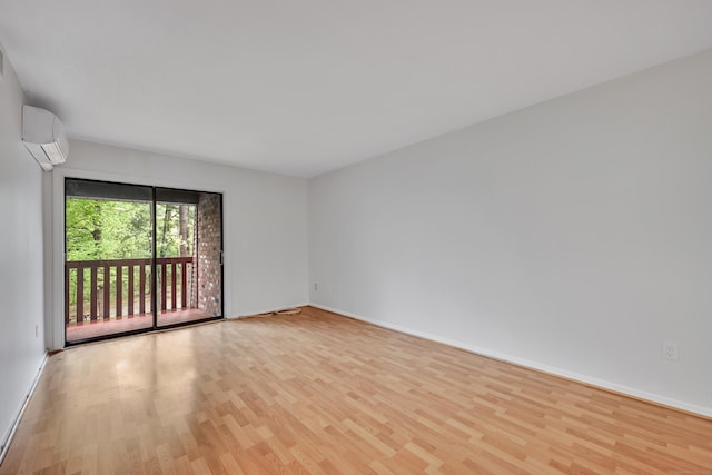 40 Woodsedge Dr Apt 2C, Newington, CT 06111 - spare room with a wall mounted air conditioner, wood finished floors, and baseboards