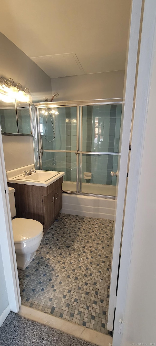 full bathroom with toilet, tile patterned floors, enclosed tub / shower combo, and vanity