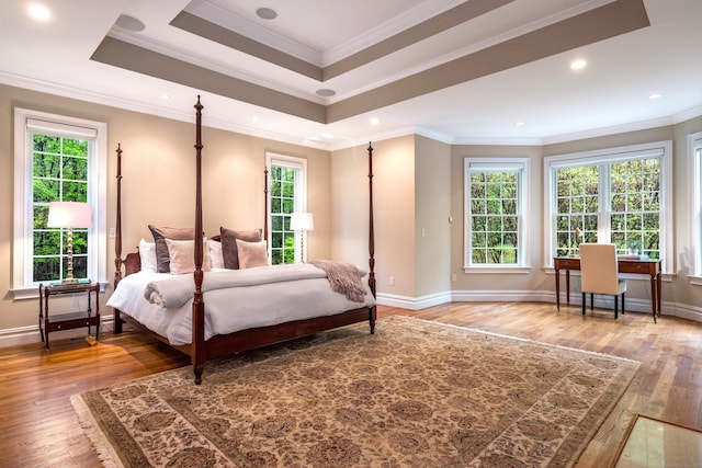 bedroom featuring wood finished floors, baseboards, ornamental molding, an office area, and recessed lighting
