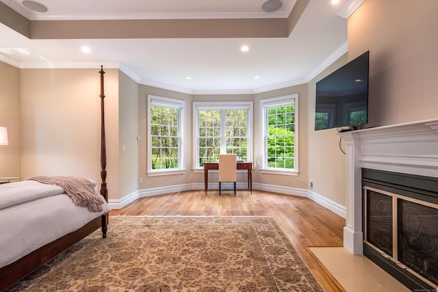 office area with wood finished floors, a fireplace with flush hearth, recessed lighting, baseboards, and ornamental molding
