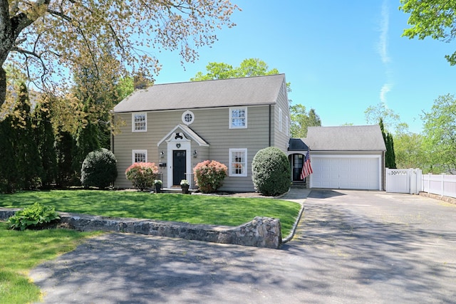 3439 Park Ave, Fairfield, CT 06825 - colonial home with concrete driveway, fence, a front lawn, and an attached garage
