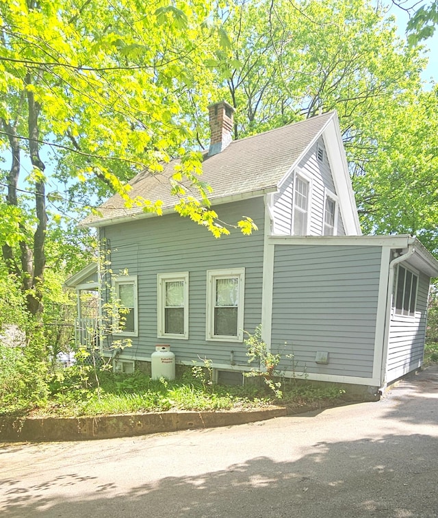 243 Bridge St, Groton, CT 06340 - view of home's exterior with a chimney