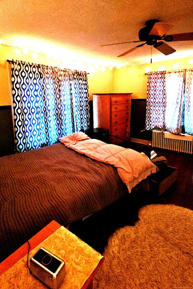 243 Bridge St, Groton, CT 06340 - carpeted bedroom with radiator and a textured ceiling