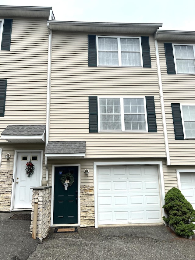 135 Bucks Hill Rd Apt 8, Waterbury, CT 06704 - view of property with an attached garage, stone siding, and driveway